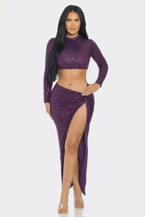 Purple sequin crop top and high-slit skirt set with long sleeves.