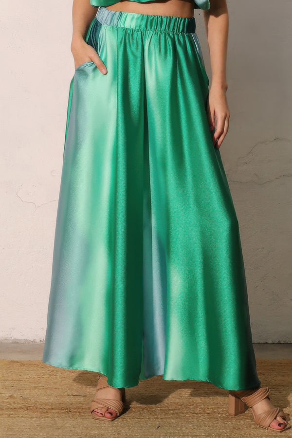 Ombre satin wide-leg pants with elastic waist, teal green gradient, flowing ankle length.